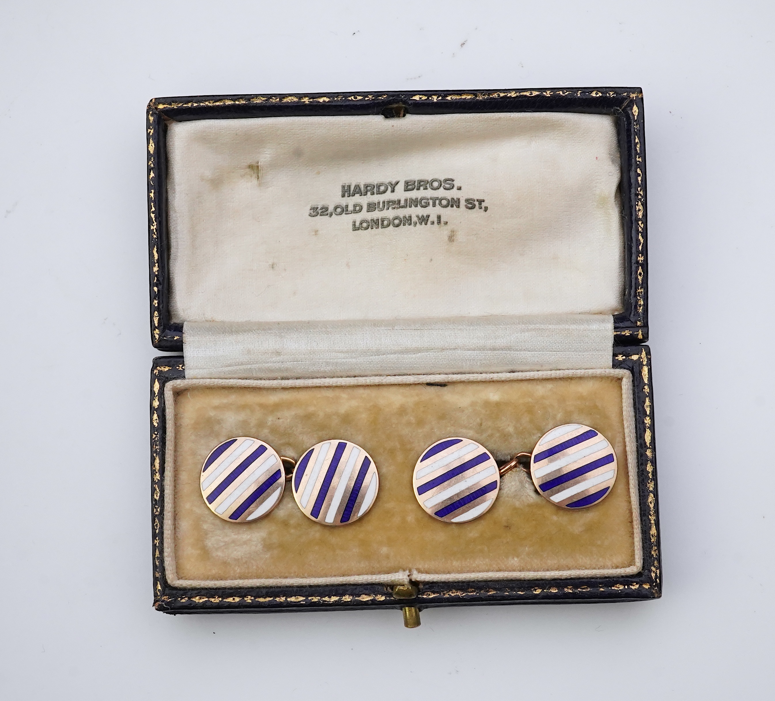 A pair of gold and enamel cufflinks